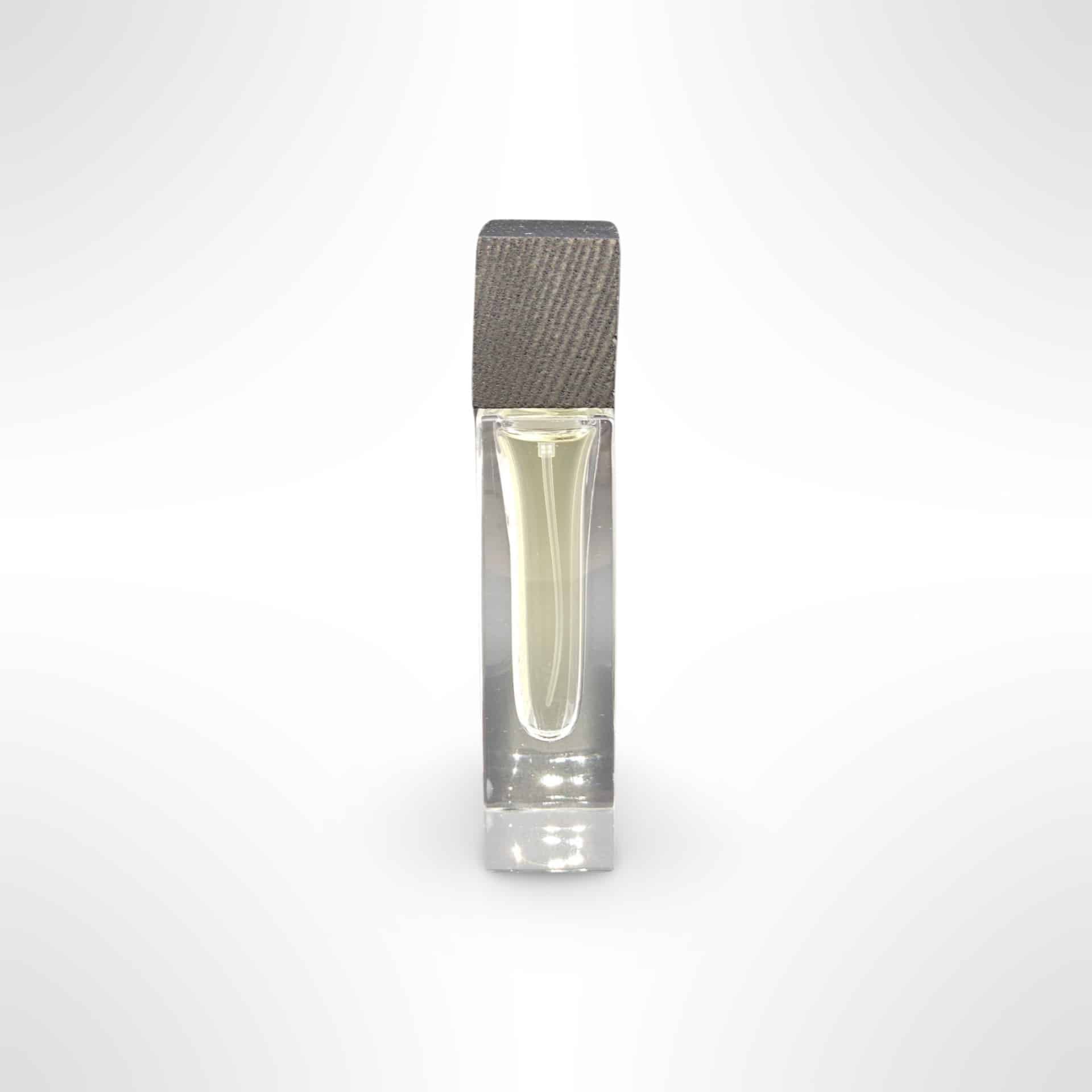 A Grasgróinn eau de parfum bottle with its grey ash wood cap
