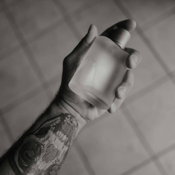 Patchouli in Perfume A hand holds a perfume bottle.