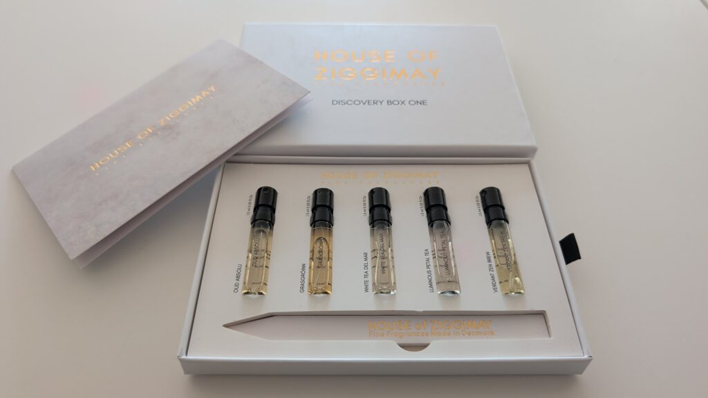 The Discovery Box open, its lid beside it, showing five 1.5 ml sample vials and a paper tester strip